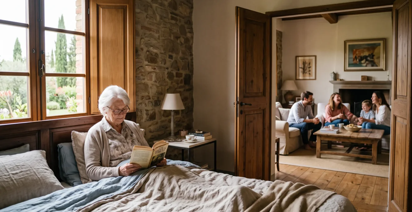 A grandmother reads alone in her villa bedroom while the family gathers nearby.